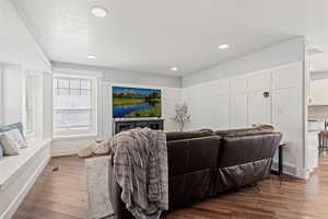Living room featuring wood finished floors and recessed lighting