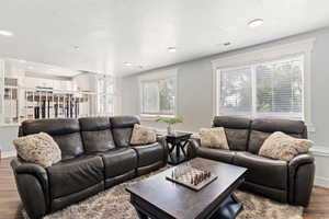 Living room with wood finished floors and recessed lighting