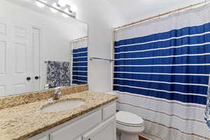 Full bath with vanity and a shower with shower curtain