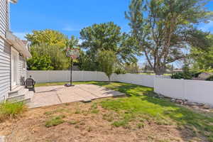 View of sport court featuring a patio and a fenced backyard