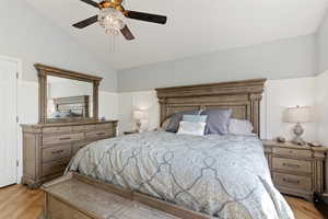 Bedroom with wood finished floors, lofted ceiling, and ceiling fan