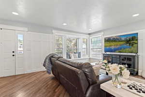 Living room with dark wood-style flooring and recessed lighting