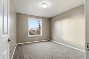 Empty room featuring carpet flooring and baseboards