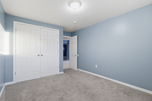 Unfurnished bedroom with carpet and a closet