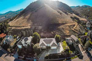 Aerial view of property's location with mountains and nearby suburban area