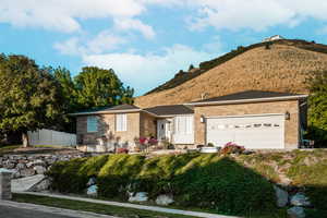 Ranch-style house with brick siding, a mountain view, and an attached garage
