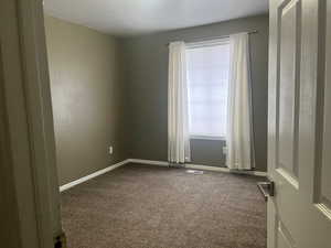 Empty room with baseboards and carpet flooring