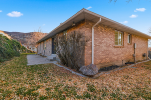 View of side of property featuring brick siding
