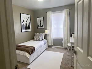 Carpeted bedroom featuring baseboards