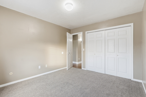 Unfurnished bedroom featuring carpet flooring and a closet
