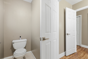 Bathroom with baseboards and toilet