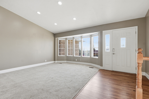 Foyer entrance with wood finished floors and recessed lighting
