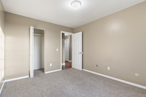 Unfurnished bedroom with carpet and a closet
