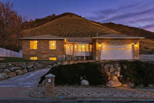 View of front facade with driveway and an attached garage