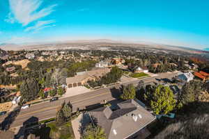 Aerial overview of property's location with mountains and nearby suburban area