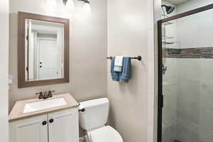 Bathroom featuring vanity and a stall shower