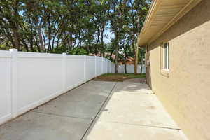 Fenced backyard with a patio