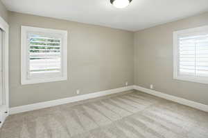 Unfurnished room featuring light carpet