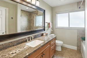 Full bath with vanity and light tile patterned flooring
