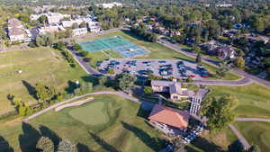 Aerial view of property's location with nearby suburban area and a local golf course