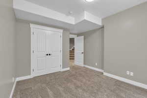 Unfurnished bedroom with carpet floors and a closet
