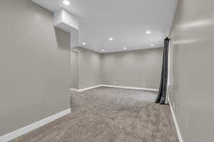 Spare room featuring light colored carpet and recessed lighting