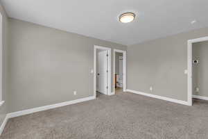 Unfurnished bedroom featuring carpet flooring and ensuite bath