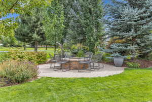 View of green lawn with a patio area