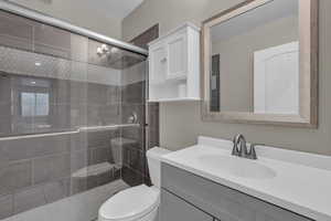 Full bath with vanity and a shower stall