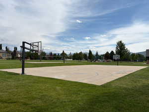 View of sport court featuring community basketball court and a yard