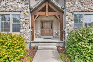 Doorway to property featuring stone siding