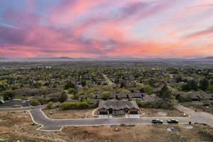 Aerial view of property's location featuring a mountainous background and nearby suburban area