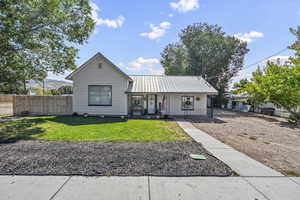 View of front facade with covered porch and a metal roof