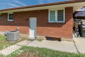 View of exterior entry with brick siding