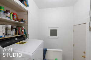 Washroom featuring washer / clothes dryer and electric panel