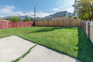 Fenced backyard with a mountain view and a patio