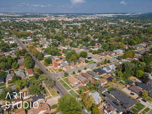 Aerial view of property and surrounding area featuring nearby suburban area