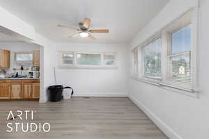 Unfurnished dining area featuring light wood finished floors and a ceiling fan