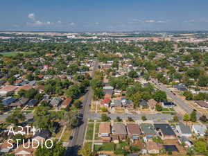 Aerial view of property and surrounding area featuring nearby suburban area