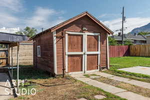 View of shed featuring a fenced backyard and a mountain view