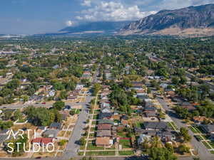 Aerial view of property's location featuring mountains and nearby suburban area
