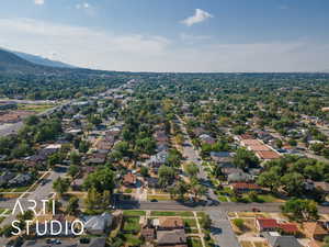 Aerial view of property and surrounding area with nearby suburban area