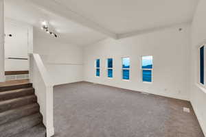 Basement featuring carpet floors and stairs