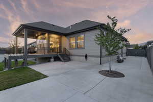 Rear view of property with a patio, a shingled roof, and a wooden deck