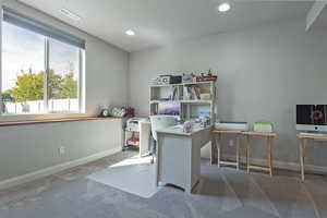 Office space with carpet, recessed lighting, and a textured ceiling