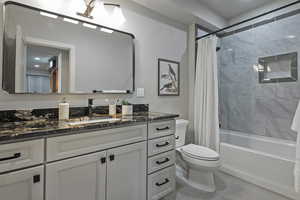Bathroom featuring vanity and shower / tub combo with curtain