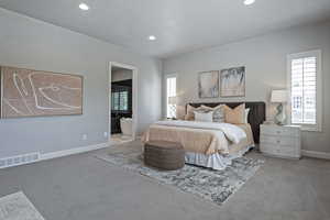 Bedroom with carpet flooring, connected bathroom, and recessed lighting