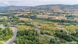 Aerial view of property and surrounding area with rural landscape and a mountain backdrop