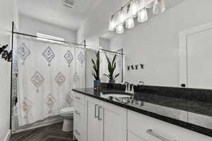 Bathroom featuring vanity and shower / bath combo with shower curtain