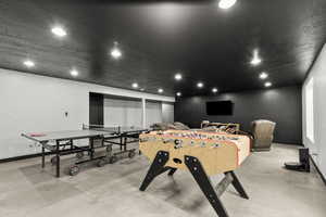 Rec room with recessed lighting and finished concrete floors